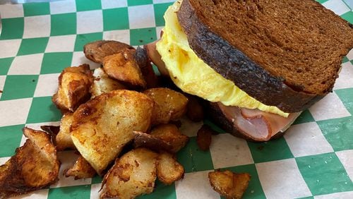 Leftie Lee’s egg melt comes with ham, scrambled eggs and Swiss cheese on griddled pumpernickel bread. Bob Townsend for The Atlanta Journal-Constitution