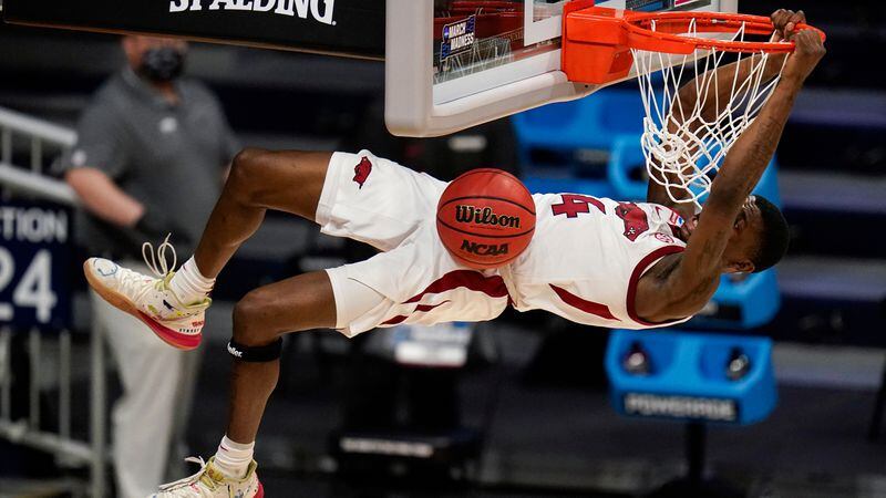 Arkansas guard Davonte Davis (4) gets a dunk against Texas Tech in the second half of a second-round game in the NCAA Tournament Sunday, March 21, 2021, at Hinkle Fieldhouse in Indianapolis. (Michael Conroy/AP)
