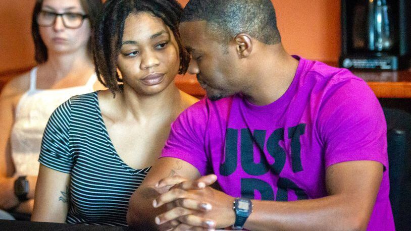 Amber Jackson sits next to her boyfriend Andre Williams at a press conference in Decatur on Friday, June 25, 2021, concerning her body-slam lawsuit against two Atlanta police officers and the city of Atlanta. (STEVE SCHAEFER FOR THE ATLANTA JOURNAL-CONSTITUTION)
