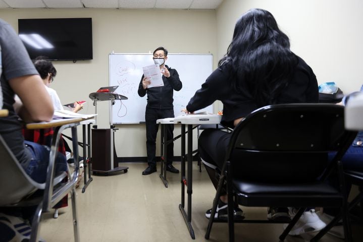 Level 1 teacher Joe Suen reviews the textbook with students on Nov. 11, 2021.The  Center for Pan Asian Community Services offers five levels of ESL education. (Miguel Martinez for The Atlanta Journal-Constitution)
