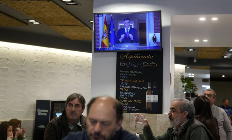 Customers have breakfast in a restaurant while Spanish Prime Minister Pedro Sanchez appears on a television broadcast in Madrid, Spain, Monday, April 29, 2024. Spain is in suspense as it waits for Prime Minister Pedro Sánchez to announce whether he will continue in office or leave. (AP Photo/Paul White)