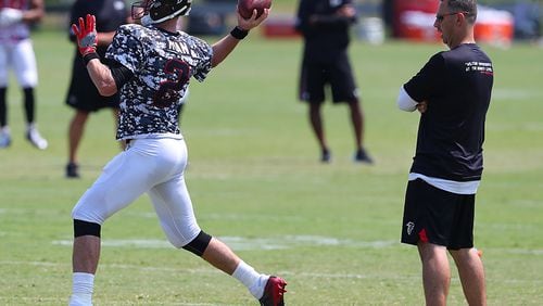 Falcons offensive coordinator Steve Sarkisian looks on as Matt Ryan throws a pass during team practice Sunday, August 6, 2017, in Flowery Branch. (Curtis Compton/ccompton@ajc.com)