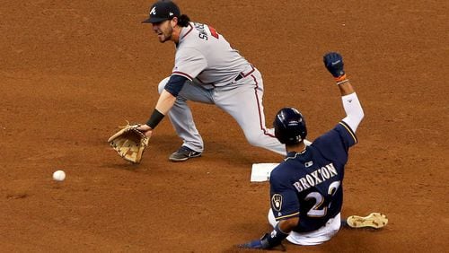 Keon Broxton steals second base past Dansby Swanson during the fifth inning of Sunday&#039;s game.