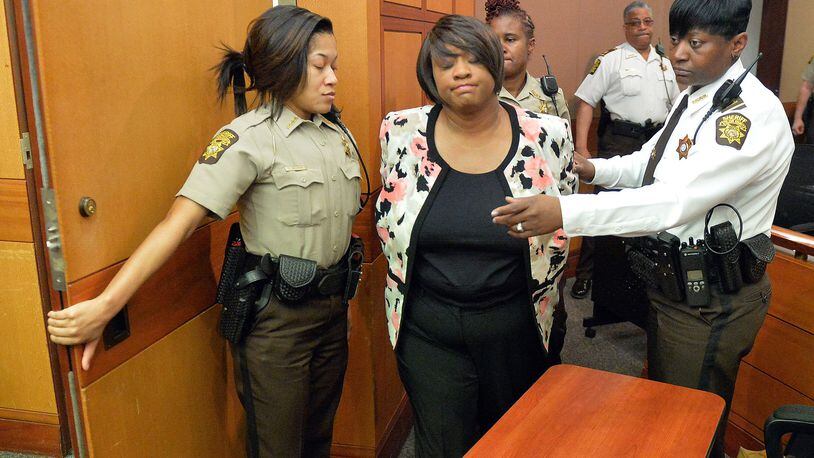 Tamara Cotman is led to a holding cell after a jury found her guilty in the Atlanta Public Schools test-cheating trial in 2015. (Kent D. Johnson/ Atlanta Journal-Constitution)