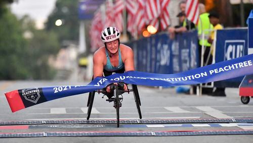 Tatyana McFadden won her eighth Atlanta Journal-Constitution Shepard Center women’s wheelchair title Sunday morning as the AJC Peachtree Road Race returned in-person for the second day Sunday for the holiday tradition.  Hyosub Shin / Hyosub.shin@ajc.com