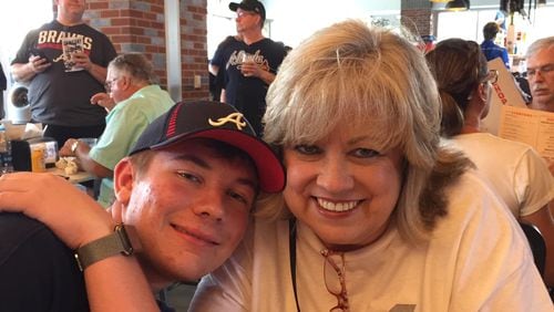 Sherry Clements Wilmot, seen here with her son J.T., said that the tipping ponit in overcoming her vaccine hesitancy was when a friend recommended that she write down every person she knew who died of COVID-19 (21 names), and everyone she knew who died of the vaccine. "Crickets. Zip. Zero," she now says. (Courtesy of Sherry Clements Wilmot)