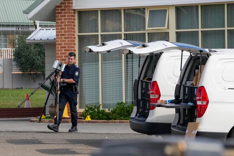A police forensic officer works at a crime scene at the Christ the Good Shepherd Church in suburban Wakely in western Sydney, Australia, Tuesday, April 16, 2024. Australian police say a knife attack in Sydney that wounded a bishop and a priest during a church service as horrified worshippers watched online and in person, and sparked a riot was an act of terrorism. (AP Photo/Mark Baker)