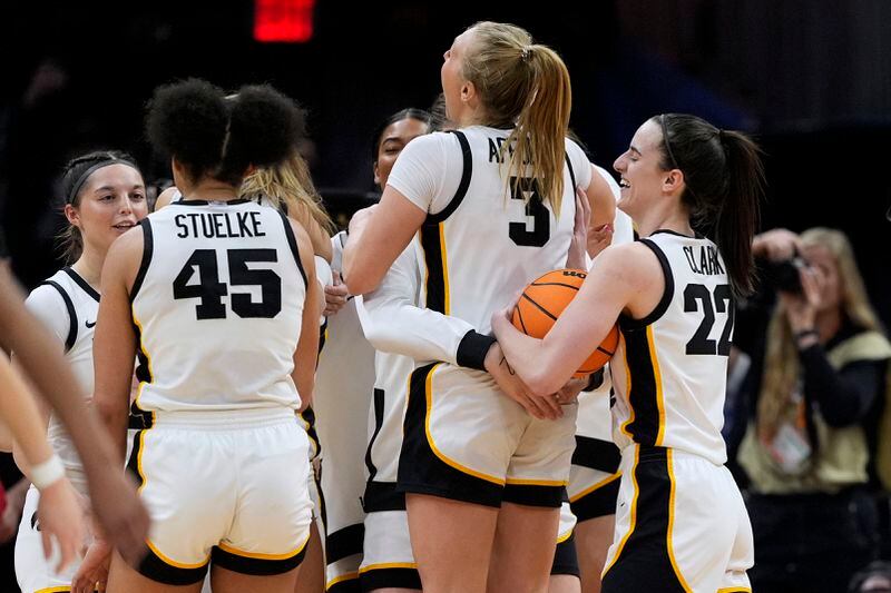 Iowa guard Caitlin Clark (22) celebrates with teammates at the end of a Final Four college basketball game against UConn in the women's NCAA Tournament, Friday, April 5, 2024, in Cleveland. Iowa won 71-69. (AP Photo/Carolyn Kaster)