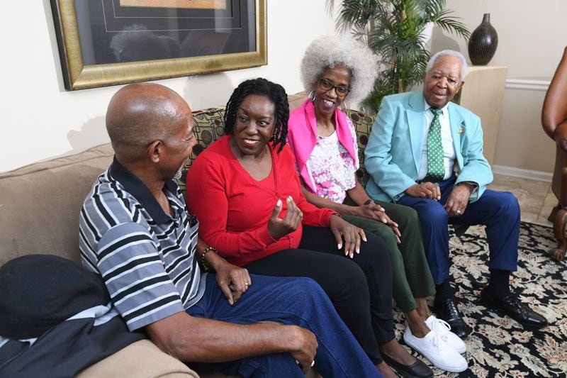 Debra Biagini (second from left) talks with her siblings Warren and Renee and their father, Ambassador Theodore Britton Jr., last Saturday in Atlanta. Biagini discovered Britton was her father last year just as she was about to celebrate her 60th birthday. CONTRIBUTED BY JOHN AMIS