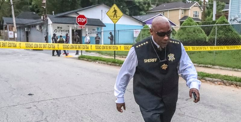 July 10, 2019  Atlanta : Clayton County Sheriff, Victor Hill leaves the scene where Atlanta police, Clayton County sheriff deputies along with the Clayton County Police Department investigated the scene on Griffin Street in northwest Atlanta after a wanted man killed himself on Wednesday July 10, 2019. A jilted Clayton County husband who confessed to his wife’s shooting on social media killed himself Wednesday when he was approached by officers in northwest Atlanta, authorities said. Atlanta police and Clayton County sheriff’s deputies tracked Orlando Rodriguez Otero’s vehicle to the area of Griffin Street around 5 a.m. With the help of a K-9, they found him standing in a grassy area outside an apartment complex at the corner of Griffin and North Avenue, Atlanta police Capt. William Ricker told AJC.com. “When the officers spotted him, he had a firearm and a phone in his hand,” Ricker said. “Shortly thereafter, he put the gun to his head and shot himself.” Clayton County authorities had been looking for Otero since he allegedly shot his wife at their Morrow Road apartment late Tuesday night.  According to the sheriff’s office, Otero’s son called 911 from inside a locked bathroom to report his father and mother were fighting. The child also told dispatchers he heard gunshots. When police got to the apartment, Otero was gone. They found the woman shot three times in the face, head and stomach, a sheriff’s spokesman said in a news release. She remains in critical condition and is “fighting for her life.” “Clayton County police detectives found that the shooting suspect, who they identified as Orlando Rodriguez Otero, shot his wife after an argument and left the scene saying that she would be all right,” the spokesman said. “... Otero then made a live social media post confessing to shooting his wife over another man.” Atlanta police were processing the suicide scene Wednesday morning. Clayton County Sheriff Victor Hill was also on scene.