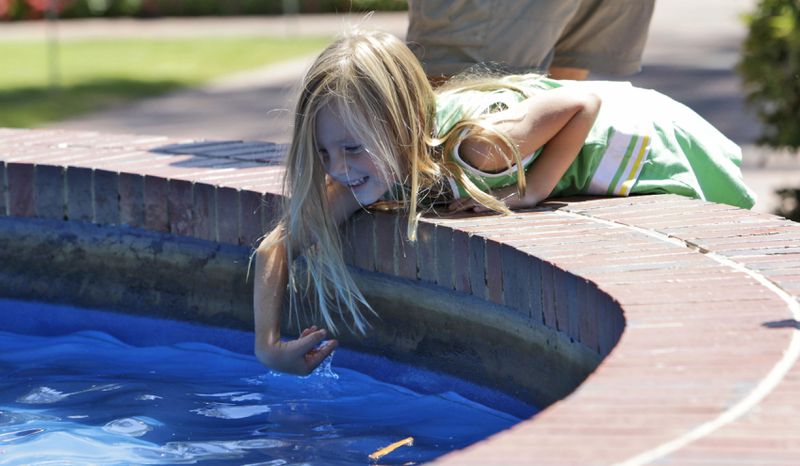 Sept. 6, 2010: Sadie Estes, 4, of Marietta, cools off in the Marietta Square fountain during the 24th Annual Art in the Park festival.