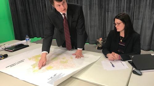 Gwinnett Departmentof Transportation Director Alan Chapman discusses the county's comprehensive transit plan during a Thursday media briefing as consultant Cristina Pastore looks on. TYLER ESTEP / TYLER.ESTEP@AJC.COM