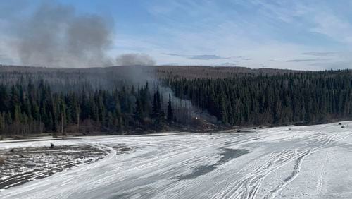 A fire burns after a Douglas C-54 Skymaster plane crashed into the Tanana River outside Fairbanks, Alaska, Tuesday, April 23, 2024. (Alaska State Troopers via AP)