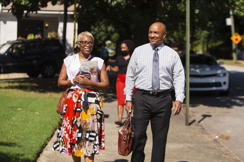 Tanya Joseph (left) and Herb Joseph (right), Jehovah's Witnesses, go door-to-door, in Atlanta's Old Fourth Ward.  The group resumed their door-to-door ministry after pausing for two-and-a-half-years due to the coronavirus pandemic. CHRISTINA MATACOTTA FOR THE ATLANTA JOURNAL-CONSTITUTION.