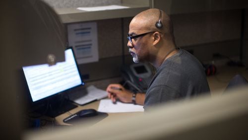 Responder Howard Hill, who is a former Marine, listens to a caller at the VA’s crisis hotline call center in Atlanta, Tuesday, Dec. 13, 2016. BRANDEN CAMP / SPECIAL
