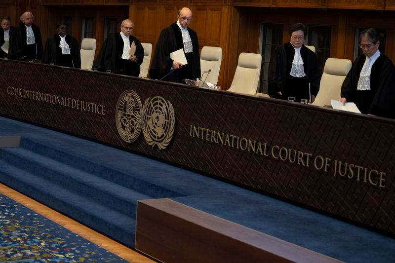 Presiding judge Nawaf Salam, fourth from left, arrives to read the ruling at the International Court of Justice in The Hague, Netherlands, Tuesday, April 30, 2024, where the United Nations' top court rejected Nicaragua's request for an order for Germany to halt military aid to Israel, arguing that Berlin's support enables acts of genocide and breaches of international humanitarian law in Gaza. (AP Photo/Peter Dejong)