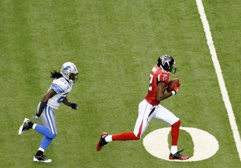 Falcons quarterback Matt Ryan threw a touchdown on his first NFL pass attempt, connecting with wide receiver Michael Jenkins (right) on a 62-yard play against the Detroit Lions Sunday, Sept. 7, 2008, at the Georgia Dome in Atlanta. (Curtis Compton/Curtis.Compton@ajc.com)