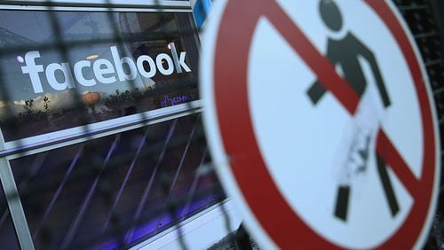 BERLIN, GERMANY - FEBRUARY 24: A no entry symbol hangs on an opened gate next to the Facebook logo at the Facebook Innovation Hub on February 24, 2016 in Berlin, Germany. The Facebook Innovation Hub is a temporary exhibition space where the company is showcasing some of its newest technologies and projects. (Photo by Sean Gallup/Getty Images)