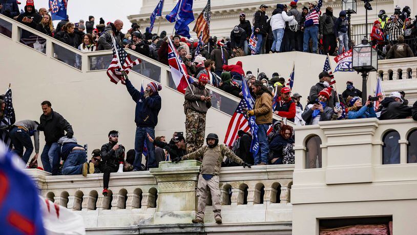 Pro-Trump supporters storm the U.S. Capitol following a rally with President Donald Trump on Wednesday in Washington. A spokeswoman for U.S. Rep. Jody Hice, R-Greensboro, said Thursday morning that after the protest turned violent, the congressman removed a post from Instagram saying "This is our 1776 moment" because he did not intend it "to be misinterpreted as a consent of the insurrection." (Samuel Corum/Getty Images/TNS)