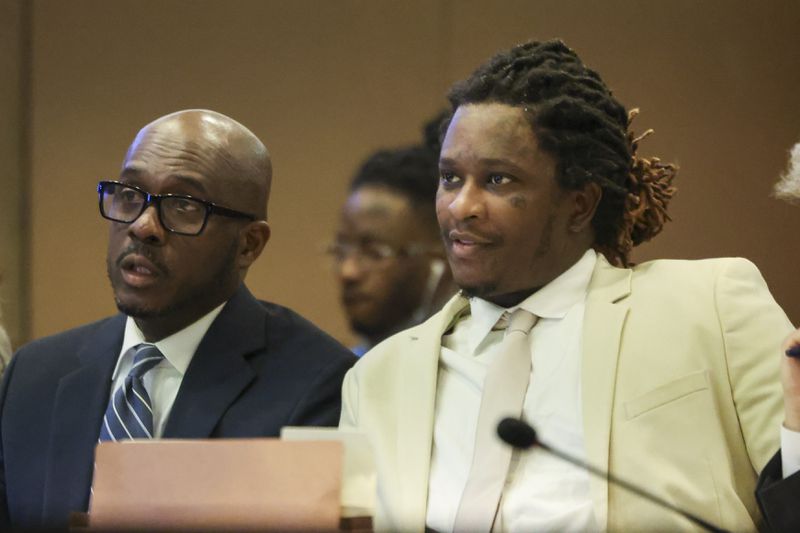 Atlanta rapper Young Thug, whose real name is Jeffery Williams, talks with one of his defense attorneys Keith Adams, left, at the courtroom of Judge Ural Glanville at the Fulton County Courthouse, Friday, March 22, 2024, in Atlanta. (Jason Getz / jason.getz@ajc.com)