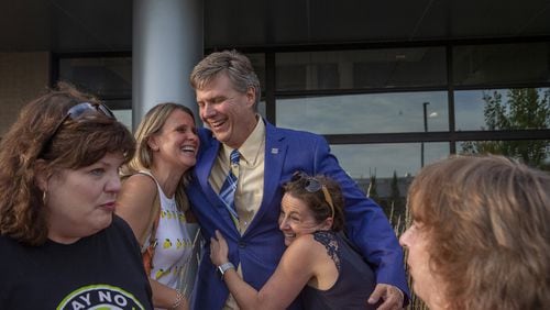 Mayor Frank Trilla hugs State Rep. Deanne Mazzochi, left, and Michele Berg after a press conference held at Village Hall to celebrate Sterigenics' announcement of its plans to exit operations in Willowbrook, Sept., 30, 2019. (Camille Fine / Chicago Tribune)