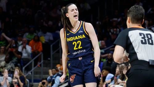 Indiana Fever guard Caitlin Clark (22) reacts after making a three-point shot against the Dallas Wings during the first half of an WNBA basketball game in Arlington, Texas, Friday, May 3, 2024.  Clark finished with a team-high 21 points in the Fever’s 79-76 loss. (AP Photo/Michael Ainsworth)