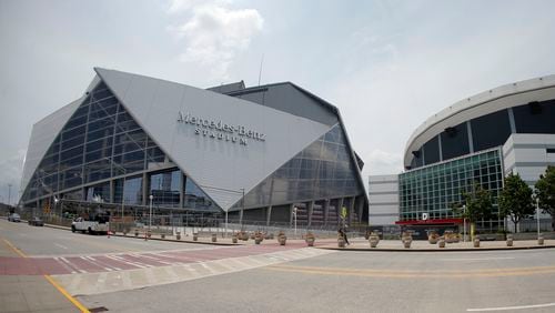 Mercedes Benz Stadium, left, the new home of the Atlanta Falcons football team and the Atlanta United soccer team, is shown next to the Georgia Dome Tuesday, July 25, 2017, in Atlanta. (AP Photo/John Bazemore)