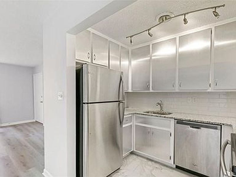 Stainless steel appliances and natural granite countertops are features of the kitchen.