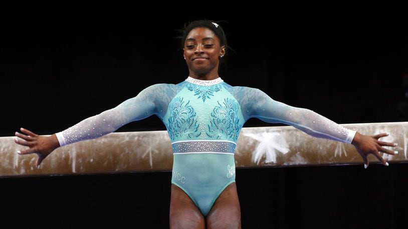 Simone Biles prepares to compete on the balance beam at the U.S. Gymnastics Championships, Sunday, Aug. 19, 2018, in Boston. (AP Photo/Elise Amendola)