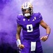 Washington quarterback Michael Penix Jr. runs out to the field through purple smoke before an NCAA college football game against Oregon, Saturday, Oct. 14, 2023, in Seattle.  The Falcons picked Penix 8th overall in the first round of the NFL draft. (AP Photo/Lindsey Wasson)