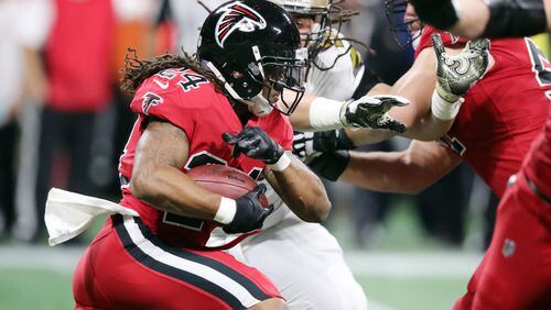 12/7/17 - Atlanta -  Atlanta Falcons running back Devonta Freeman (24) gains five yards on the Falcons first possession. The drive ended in a field goal.  Atlanta Falcons play their rival, the New Orleans Saints in an NFL football game at Mercedes-Benz Stadium in Atlanta.   Curtis Compton / ccompton@ajc.com