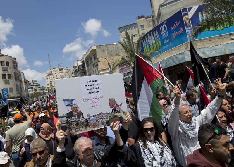 Demonstrators fly Palestinian flags and chant anti-Israel slogans to protest the new U.S. Embassy in Jerusalem.