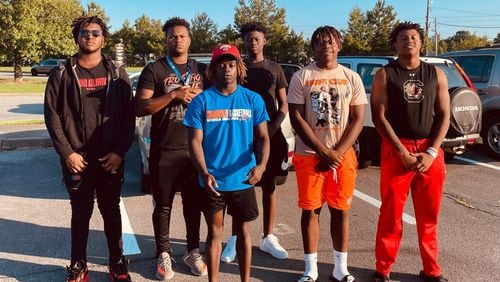 Rome High School football players Cesar Parker (from left), Treyvon Adams, Antwiion Carey, Messiah Daniels, Tyson Brown and Alto Moore rushed to the aid of a motorist involved in a wreck Friday morning in front of the school. (Courtesy of Rome City Schools)