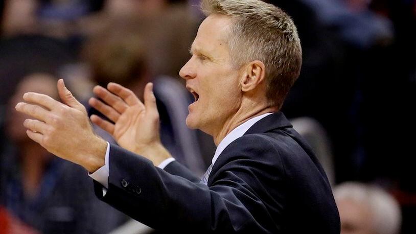 Golden State Warriors coach Steve Kerr reacts to a call during the second half of the Warriors' NBA basketball game against the Phoenix Suns, Wednesday, Feb. 10, 2016, in Phoenix. (AP Photo/Matt York)