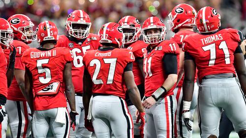 Georgia quarterback Jake Fromm (11) confers with teammates in the second half during College Football Playoff Championship at Mercedes-Benz Stadium Monday, Jan. 8, 2018.
