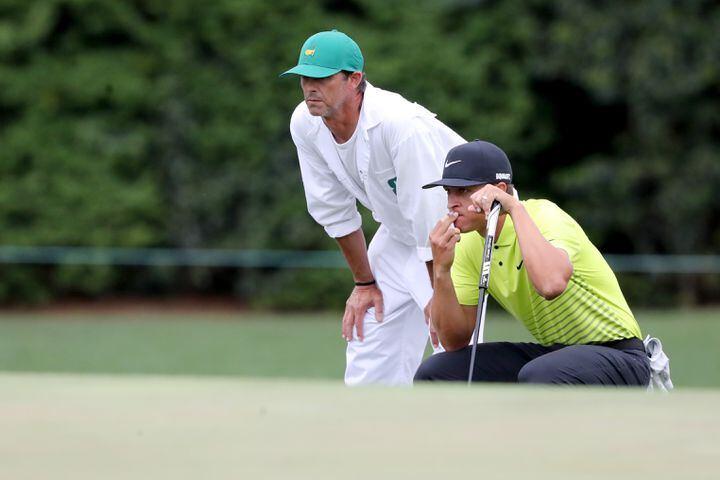 April 9, 2021, Augusta: Cameron Champ and his caddie Chad Reynolds look over his eagle attempt on the fifteenth hole during the second round of the Masters at Augusta National Golf Club on Friday, April 9, 2021, in Augusta. Curtis Compton/ccompton@ajc.com