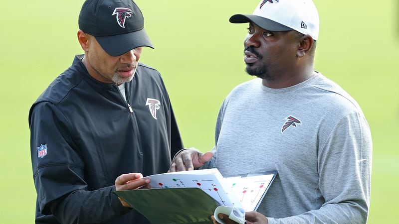 July 27, 2017 Flowery Branch: Falcons defensive coordinator Marquand Manuel(right) confers with passing game coordinator Jerome Henderson during the first day of team practice at training camp on Thursday, July 27, 2017, in Flowery Branch. Curtis Compton/ccompton@ajc.com