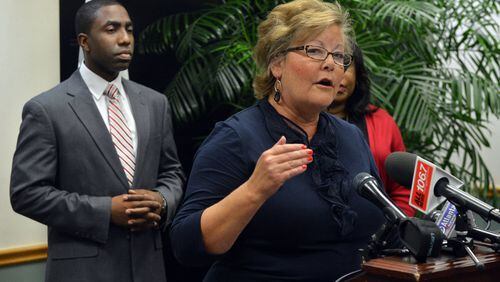 Commissioner Elaine Boyer speaks during a press conference held by Interim DeKalb CEO Lee May (left) and DeKalb commissioners and how they plan to respond to the Grand Jury report in August 2013. Boyer charged personal expenses to a county-issued purchasing card. Boyer said the charges were inadvertent and said she planned to stop using the card. KENT D. JOHNSON / KDJOHNSON@AJC.COM