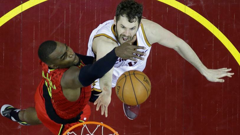 Cleveland Cavaliers' Kevin Love (0) shoots against Atlanta Hawks' Paul Millsap (4) in the second half in Game 1 of a second-round NBA basketball playoff series, Monday, May 2, 2016, in Cleveland. The Cavaliers won 104-93. (AP Photo/Tony Dejak)