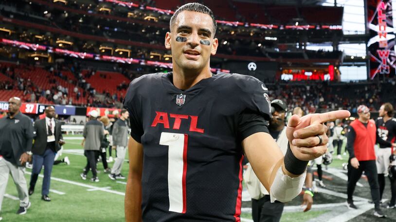 Falcons quarterback Marcus Mariota walks off the field after an overtime victory against the Panthers on Sunday. The Falcons are building something good. They’ll have more ways to improve the roster after this season. (Miguel Martinez / miguel.martinezjimenez@ajc.com)