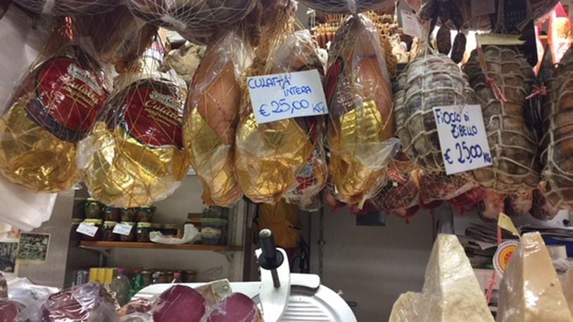 Cured hams and aged cheeses at Florence's Mercato Centrale. Many vendors will put together a sample plate for a couple of euros. (Kathleen Purvis/Charlotte Observer/TNS)