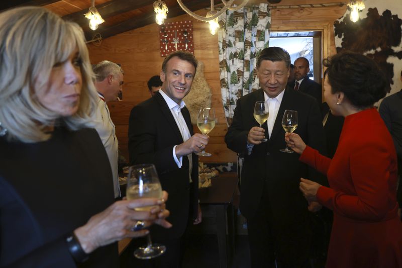 Chinese President Xi Jinping and his wife Peng Liyuan, right, enjoy a drink with French President Emmanuel Macron and his wife Brigitte Macron, left, in a restaurant, Tuesday, May 7, 2024 at the Tourmalet pass, in the Pyrenees mountains. French president is hosting China's leader at a remote mountain pass in the Pyrenees for private meetings, after a high-stakes state visit in Paris dominated by trade disputes and Russia's war in Ukraine. French President Emmanuel Macron made a point of inviting Chinese President Xi Jinping to the Tourmalet Pass near the Spanish border, where Macron spent time as a child visiting his grandmother. (AP Photo/Aurelien Morissard, Pool)