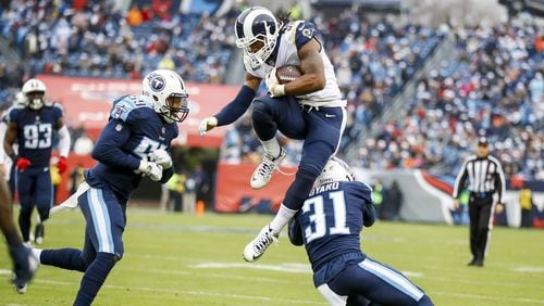 Los Angeles Rams running back Todd Gurley jumps over Tennessee safety Kevin Byard in a game last month.