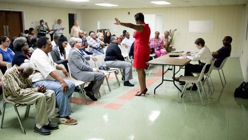 Keisha Waites, who is running for the chair of Fulton County, speaks to a group of people during a candidate forum at the Cliftondale Community Club Atlanta. Robb Pitts sits in the front row. BRANDEN CAMP/SPECIAL