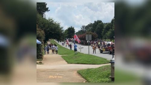 People displayed the Confederate flag along the route of the annual Old Soldiers Day Parade in Alpharetta. Participants in the parade could not display the flag.