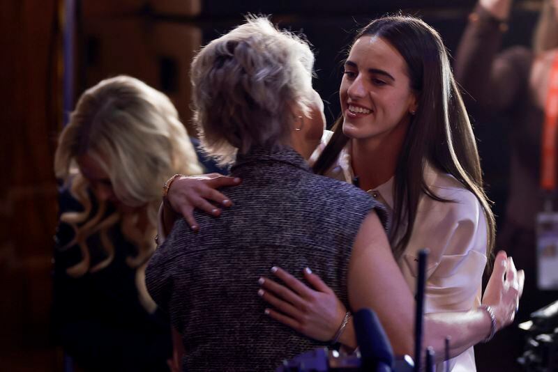 Iowa's Caitlyn Clark, right, hugs Iowa head coach Lisa Bluder after being selected first overall by the Indiana Fever during the first round of the WNBA basketball draft, Monday, April 15, 2024, in New York. (AP Photo/Adam Hunger)