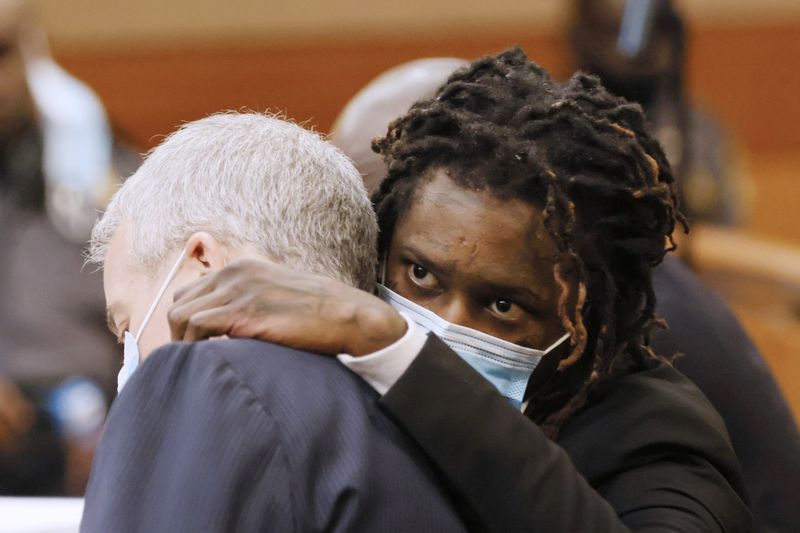 Atlanta rapper Young Thug, whose real name is Jeffery Williams, speaks with attorney Brian Steel during the jury selection in his gang and racketeering trial. 
File photo. Miguel Martinez / miguel.martinezjimenez@ajc.com