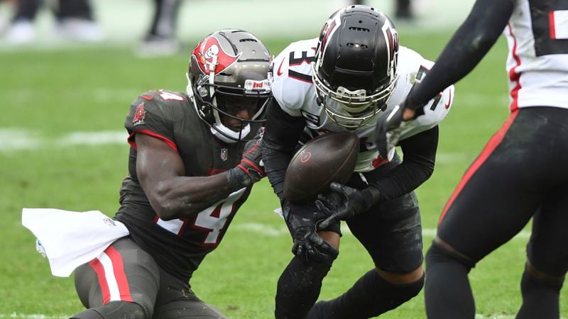 Tampa Bay Buccaneers wide receiver Chris Godwin (14) nearly strips the ball away from Atlanta Falcons free safety Ricardo Allen (37) after Allen intercepted a pass during the second half Sunday, Jan. 3, 2021, in Tampa, Fla. (Jason Behnken/AP)