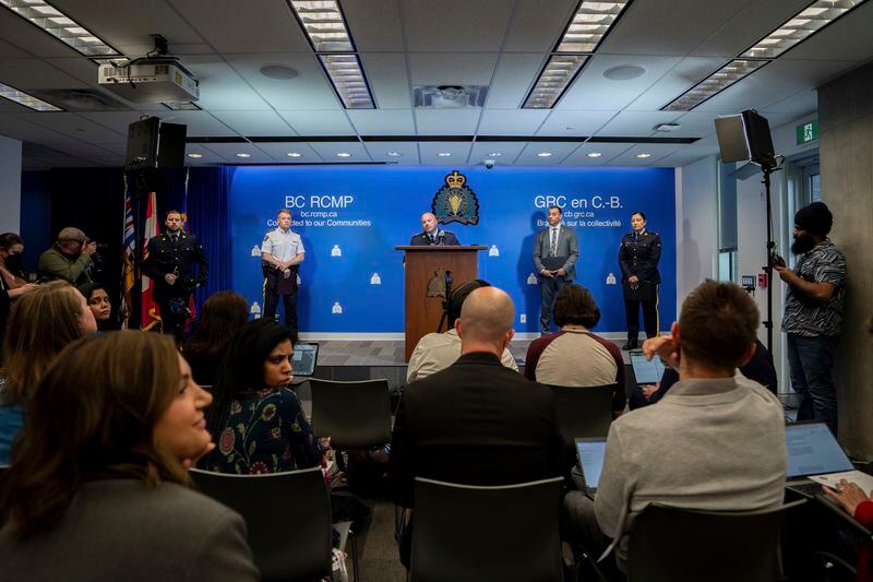 Media ask questions to Assistant Commissioner David Teboul, centre, Commander of the Federal Policing Program in the Pacific Region, along with Assistant Commissioner Brian Edwards, left, Officer-in-Charge of Surrey RCMP Detachment, and Superintendent Mandeep Mooker, second from the right, Officer-in-Charge of IHIT during a news conference for an update on the Hardeep Singh Nijjar homicide investigation from June 18, 2023, in Surrey, B.C., Friday, May 3, 2024. (Ethan Cairns/The Canadian Press via AP)