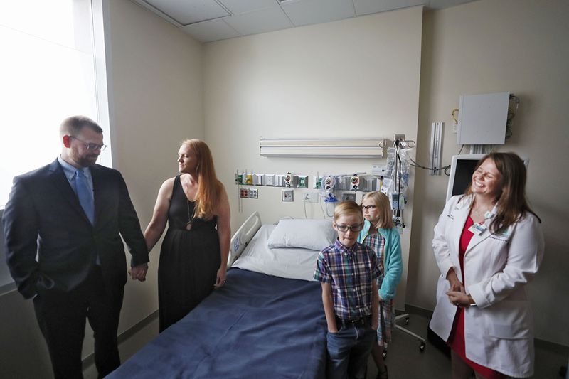 August 2, 2019, 2019 - Atlanta - Dr. Kent Brantly (from left) tours the Serious Communicable Diseases Unit with his wife, Amber, children, Stephen, 8, and Ruby, 10, and Sharon Vanairsdale, a member of the nursing staff that treated him.  Members of the Emory University Hospital medical team who successfully treated the first patients with Ebola virus disease in the United States reunited with former patients Dr. Kent Brantly, and Nancy Writebol  on Friday, Aug. 2. This marks the fifth anniversary of Dr. Brantly's arrival at Emory University Hospital as the first patient with Ebola virus disease to be treated in the U.S.   Bob Andres / robert.andres@ajc.com